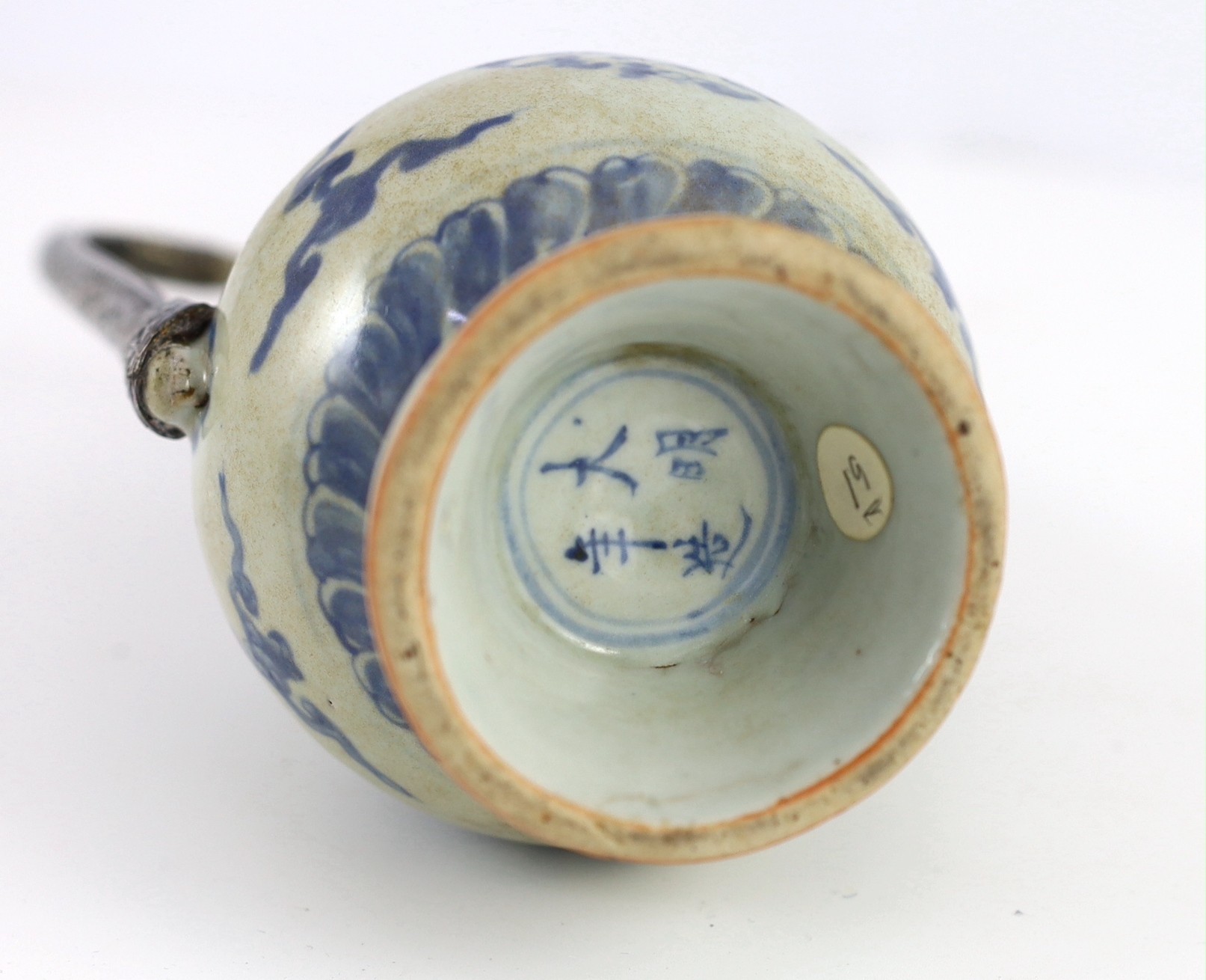 A Chinese late Ming blue and white ewer, made for the Islamic market, Jiajing to Wanli period, 21cm high, damage and later Islamic silver mounts